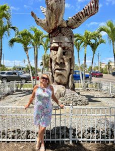 Downtown Punta Gorda with woman standing near wood carved totem