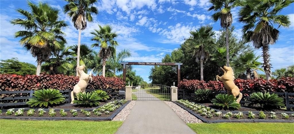 The entrance to Tall Palms Ranch with horse statues and great landscaping